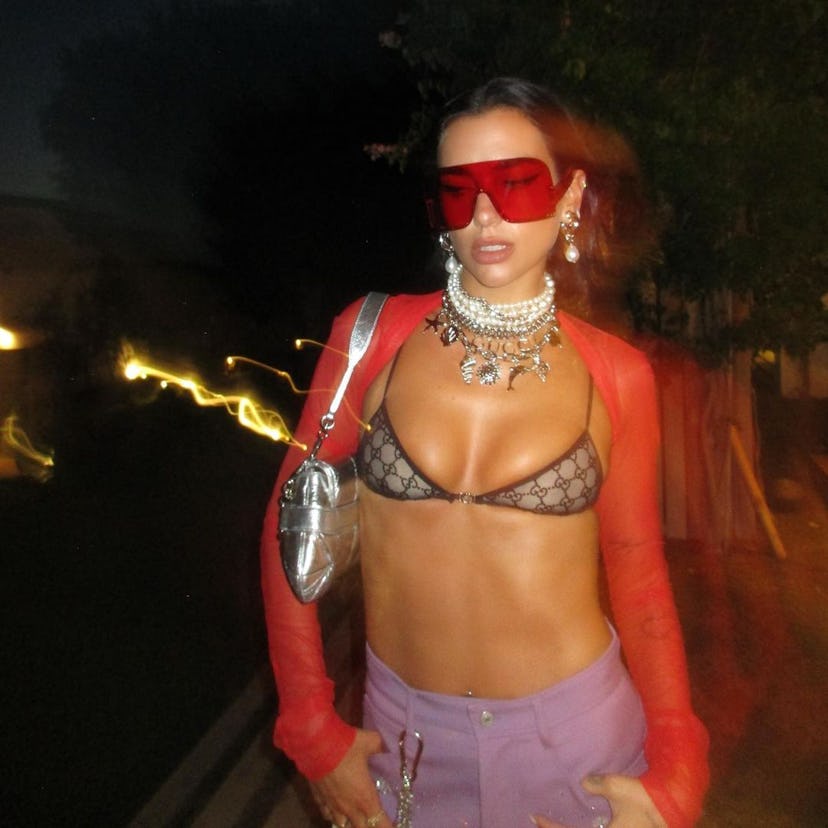 Dua Lipa wears a sheer Gucci bra and purple pants in a photo posted to her Instagram.