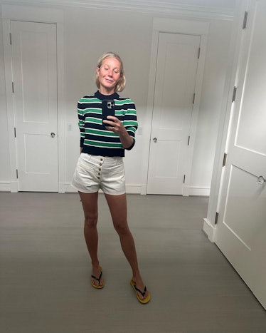 Gwyneth Paltrow wears The Row flip flops, white shorts, and a striped sweater in a photo posted to h...