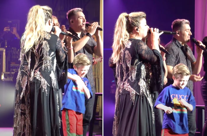 Kelly Clarkson and her son performing on stage. 