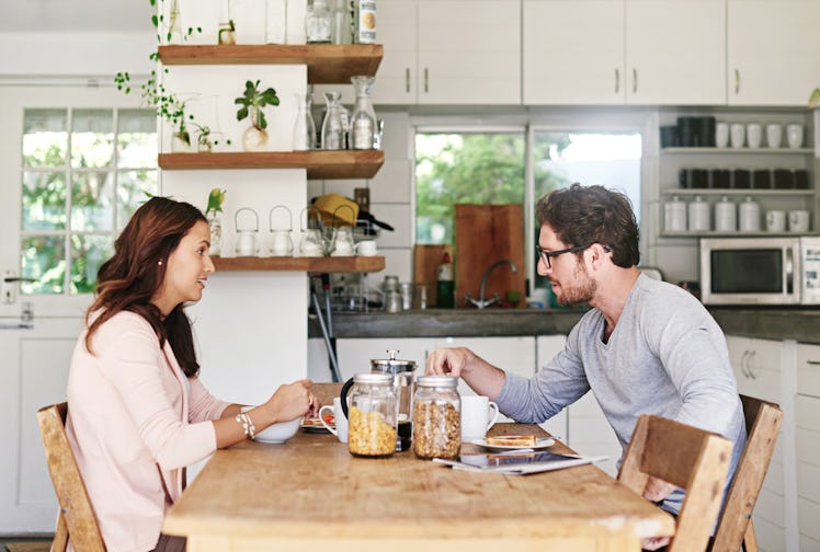 Couple at breakfast looking frustrated at one another