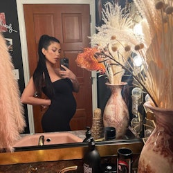 Kourtney Kardashian pregnant belly and long ponytail