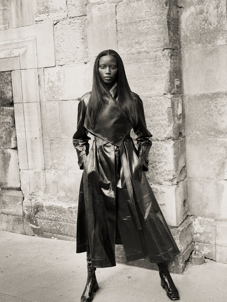 Model Anok Yai wears a leather trench coat; leather boots.