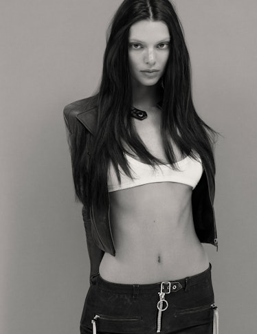 Model Kendall Jenner wears a cropped leather jacket; white bralette and black denim pants. 