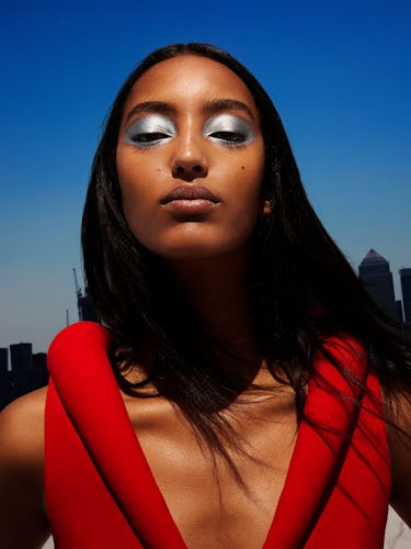 Model Mona Tougaard wears a red dress and silver eyeshadow.