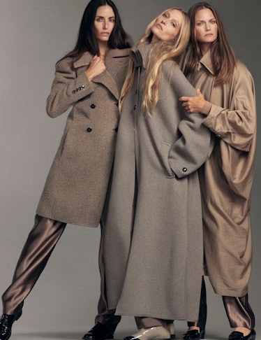 Models wears wool trench coats, shoes, silk pants.