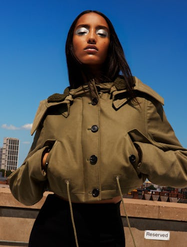 Model Mona Tougaard wears a green bomber jacket and black skirt.