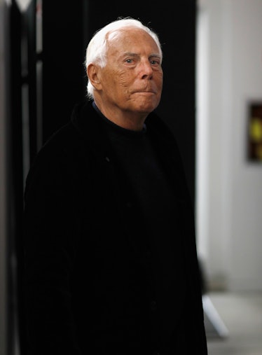 Designer Giorgio Armani wears a black shirt and jacket.