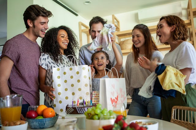 A group of people celebrate a child's birthday.
