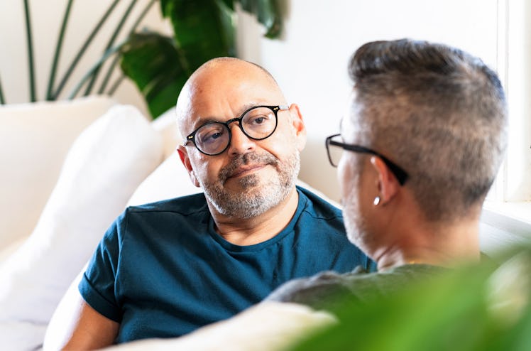 Man sitting on couch with partner, listening to them vent