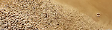 This tan-coloured slice of Mars is largely covered by wrinkled, crumpled terrain, stretching from th...
