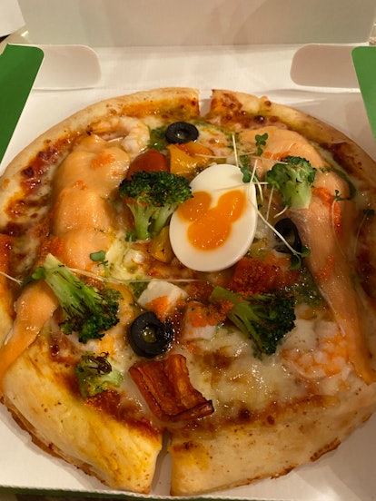 I tried the seafood pizza at Tokyo DisneySea, which has a Mickey Mouse egg on top. 