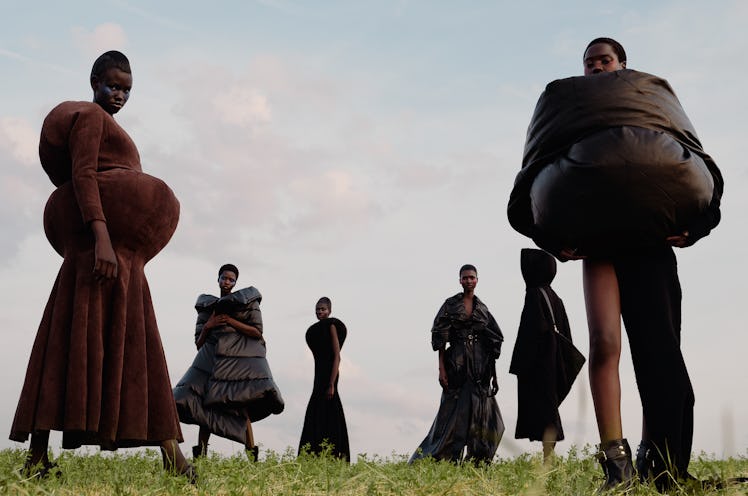 From left: Rejoice Chuol wears a Duran Lantink dress; The Row shoes. Ajah Angau Jok wears a Junya Wa...