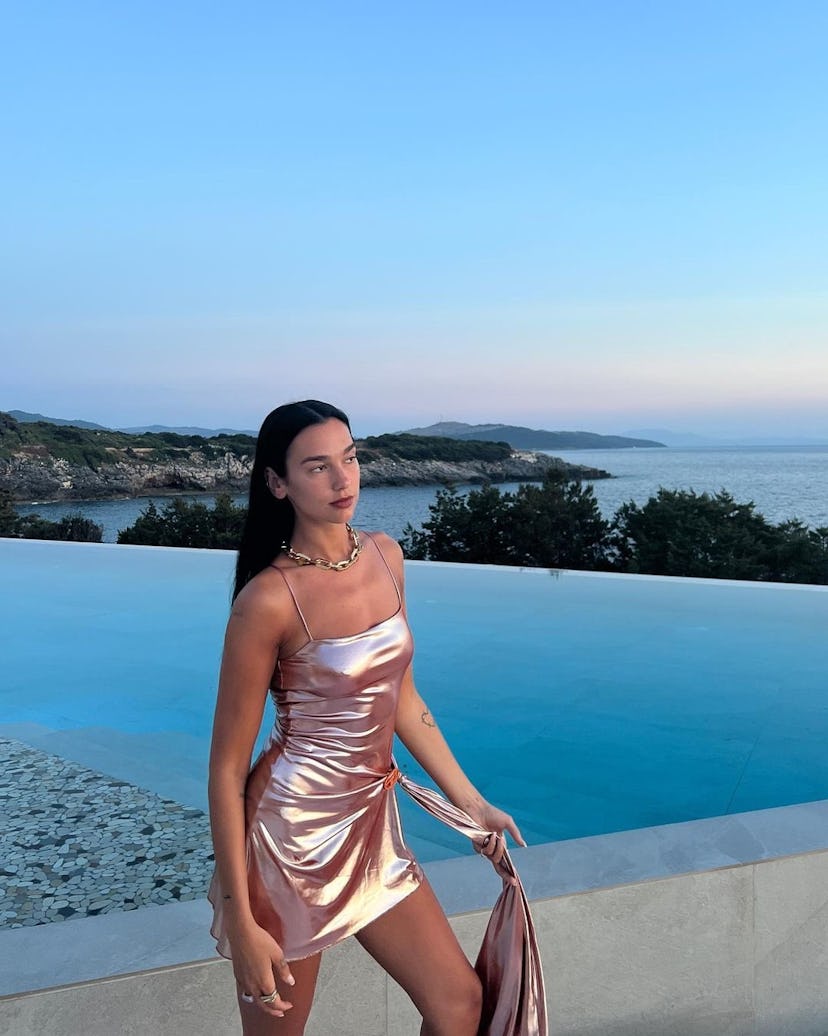 Dua Lipa wears a metallic mini during a vacation.