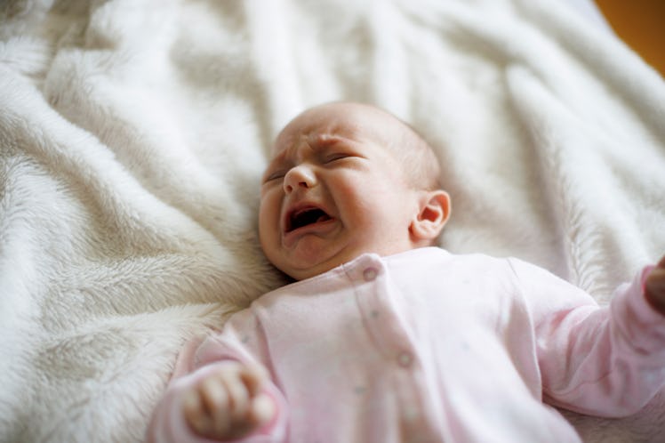 A fussy baby who is crying because they're too hot.
