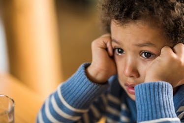 A child crying because their parents yelled at them.