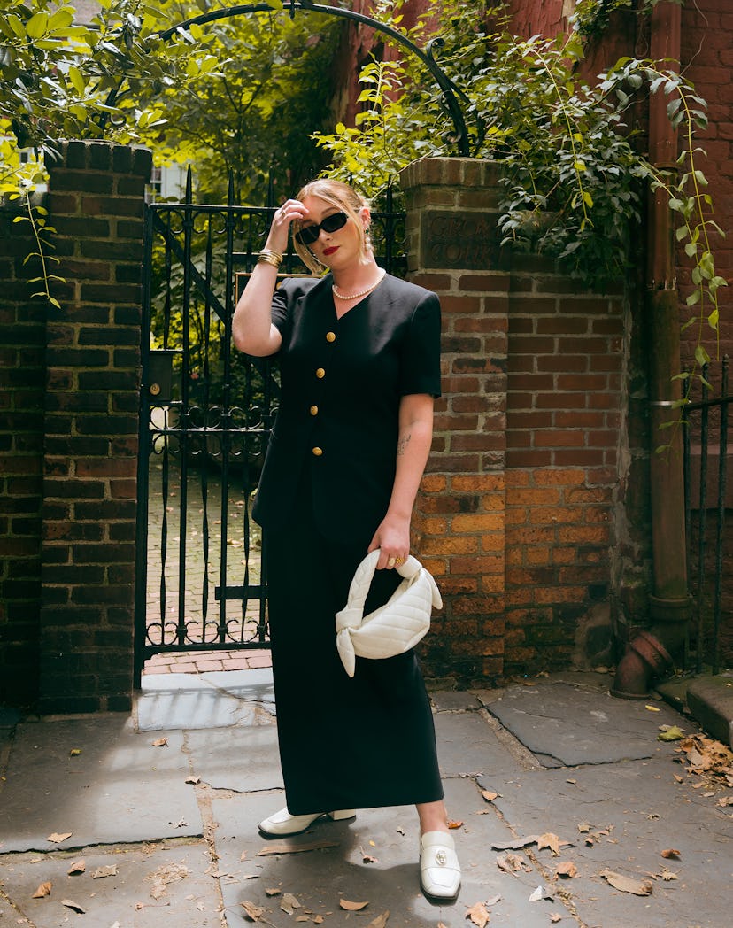 An editor wears a maxi skirt, a fall 2023 trend, in black, with a black buttoned top