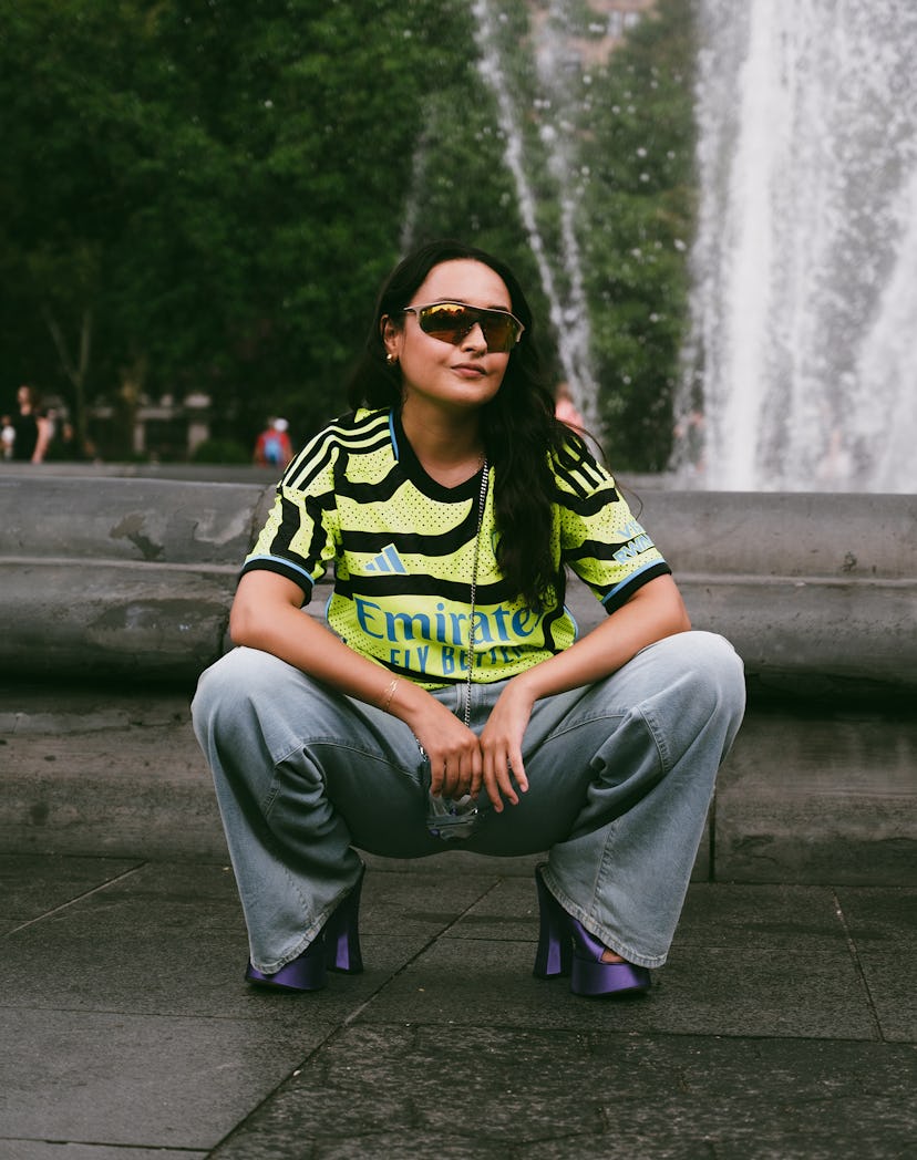 An editor wears a soccer jersey, a fall 2023 trend.