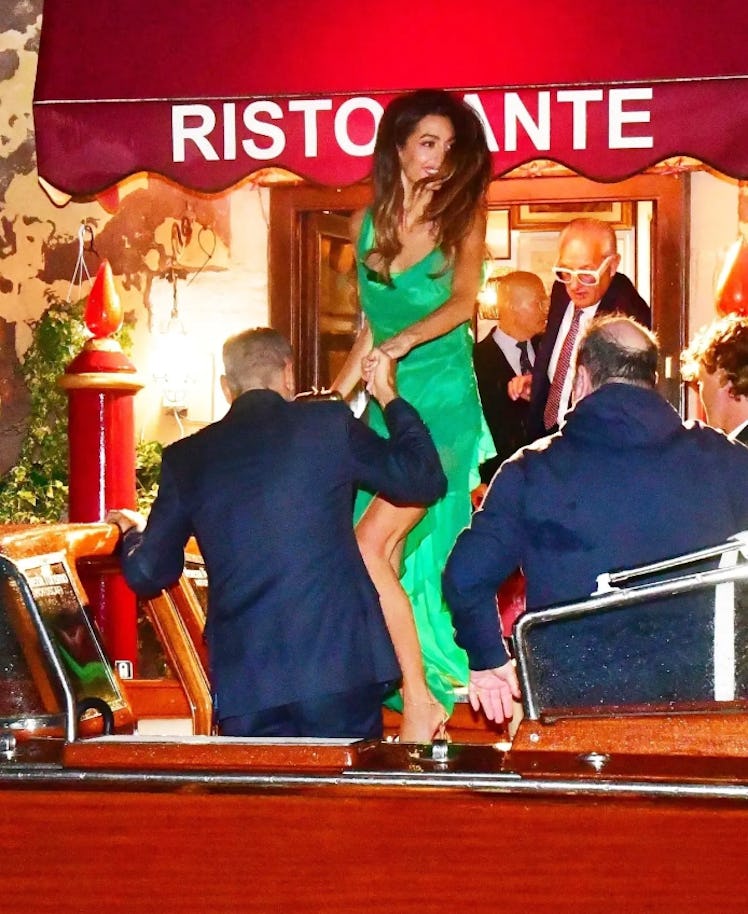 Amal Clooney wears a green Dundas slip dress in Venice, Italy.