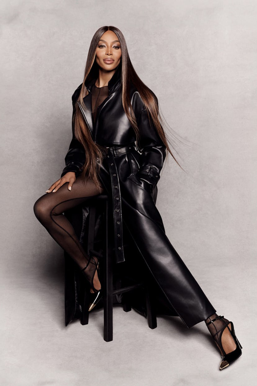 Naomi Campbell in her Pretty Little Thing collab campaign wearing a leather trenchcoat