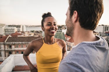 A woman flirting with a divorced man on a rooftop.