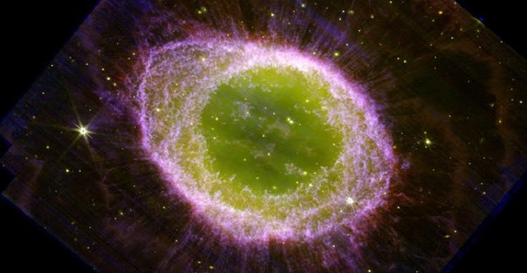 image of a round nebula in space with a green center and purple edges