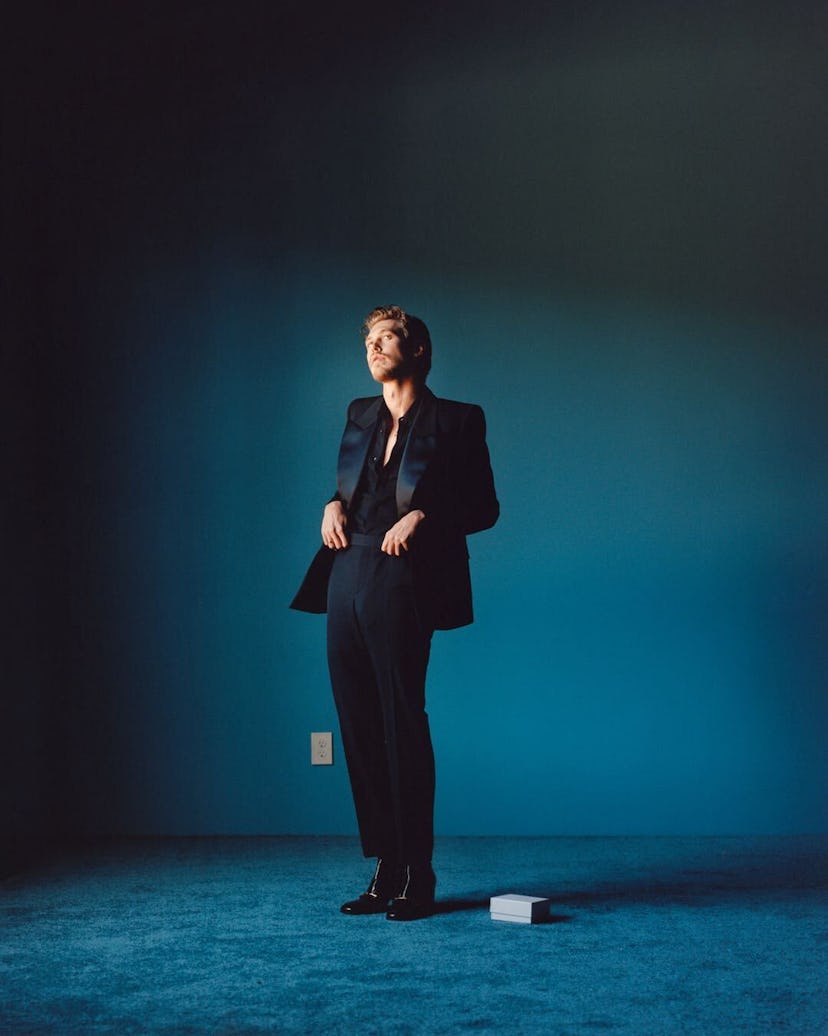 Butler wears a Saint Laurent by Anthony Vaccarello jacket, shirt, pants, and boots; Cartier ring. Ph...