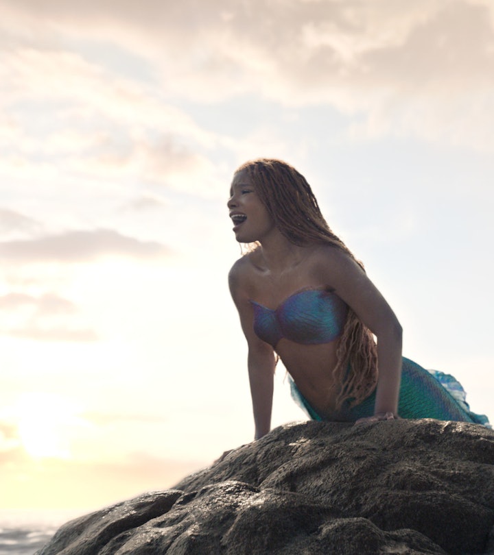 Halle Bailey singing on a rock as Ariel in 'The Little Mermaid,' coming to Disney+ this September.