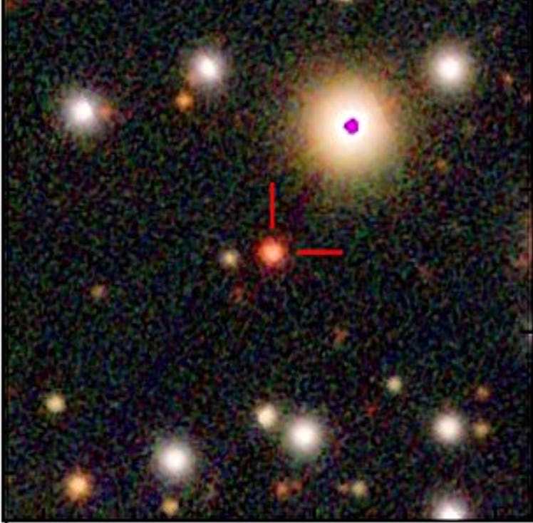 a star field in space, with a central star marked by two red lines at a right angle