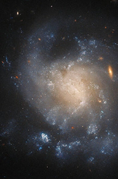 Hubble Space Telescope took this image of galaxy IC 1776. The view is of the top of the galaxy, wher...
