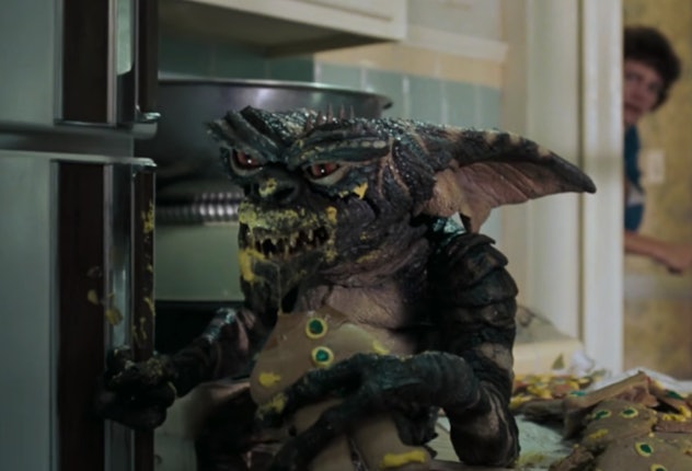 A Gremlins eats a Christmas cookie.
