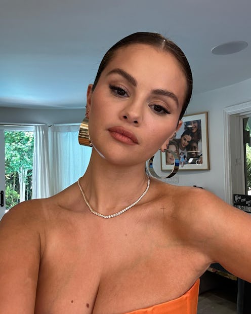 Selena Gomez shared a selfie in a bodysuit that showed makeup, perfume, & skin care products on her ...