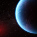 A large blue planet in the foreground with a small red star in the background
