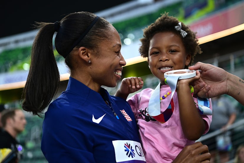 Allyson Felix of Team United States with her daughter Camryn after winning bronze in the 4x400m Mixe...