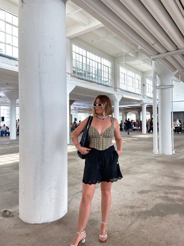 kelsey stiegman wears karen millen tweed corset top and adidas shorts to new york fashion week 2023
