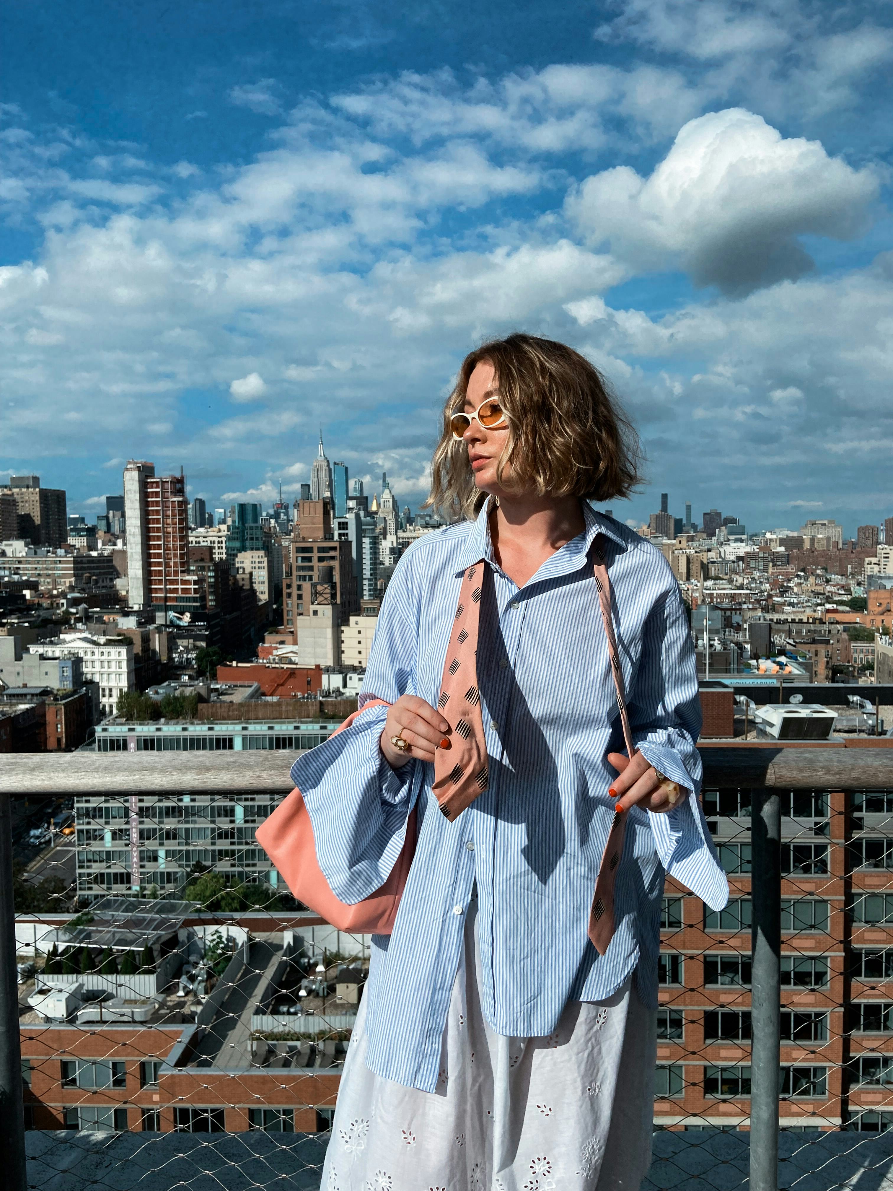 kelsey stiegman wears a blue pin-stripe button-up and eyelet skirt at new york fashion week septembe&hellip;