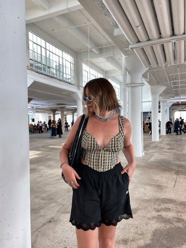 kelsey stiegman wears karen millen tweed corset top and adidas shorts to new york fashion week 2023