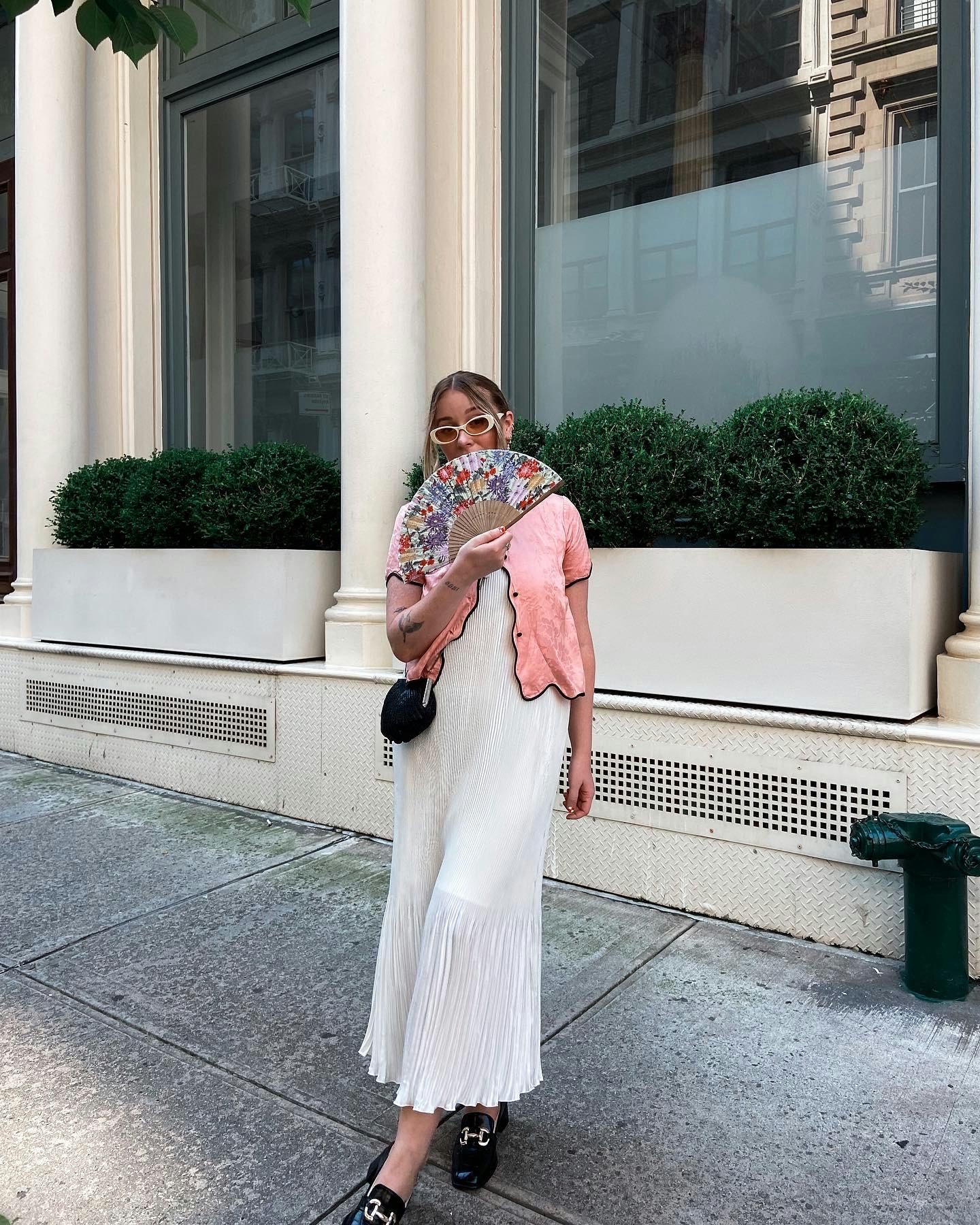 kelsey stiegman wears a pink top and pleated dress for new york fashion week september 2023
