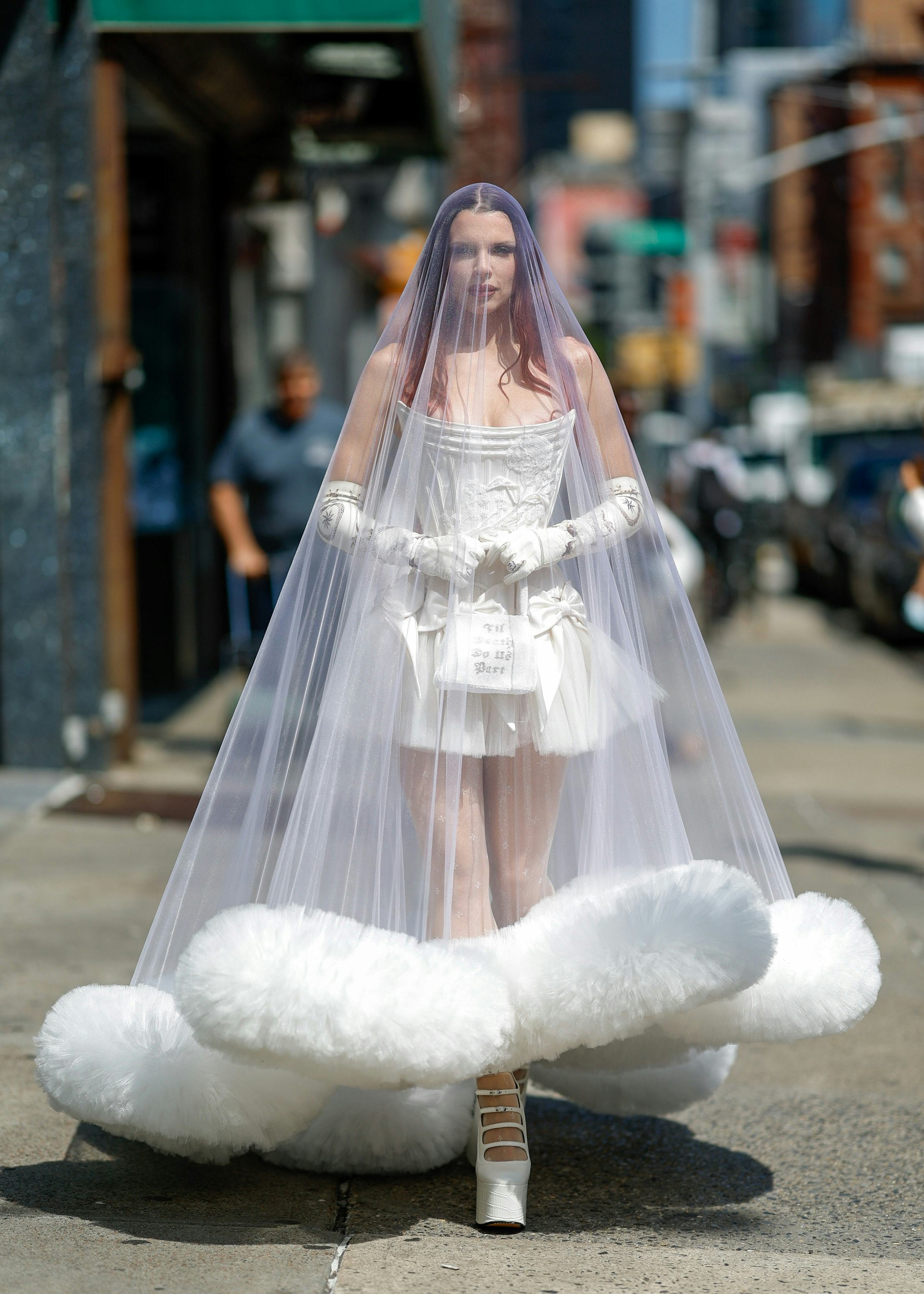 Julia Fox wears a wedding gown, veil, and gloves to Wiederhoeft&rsquo;s NYFW show.