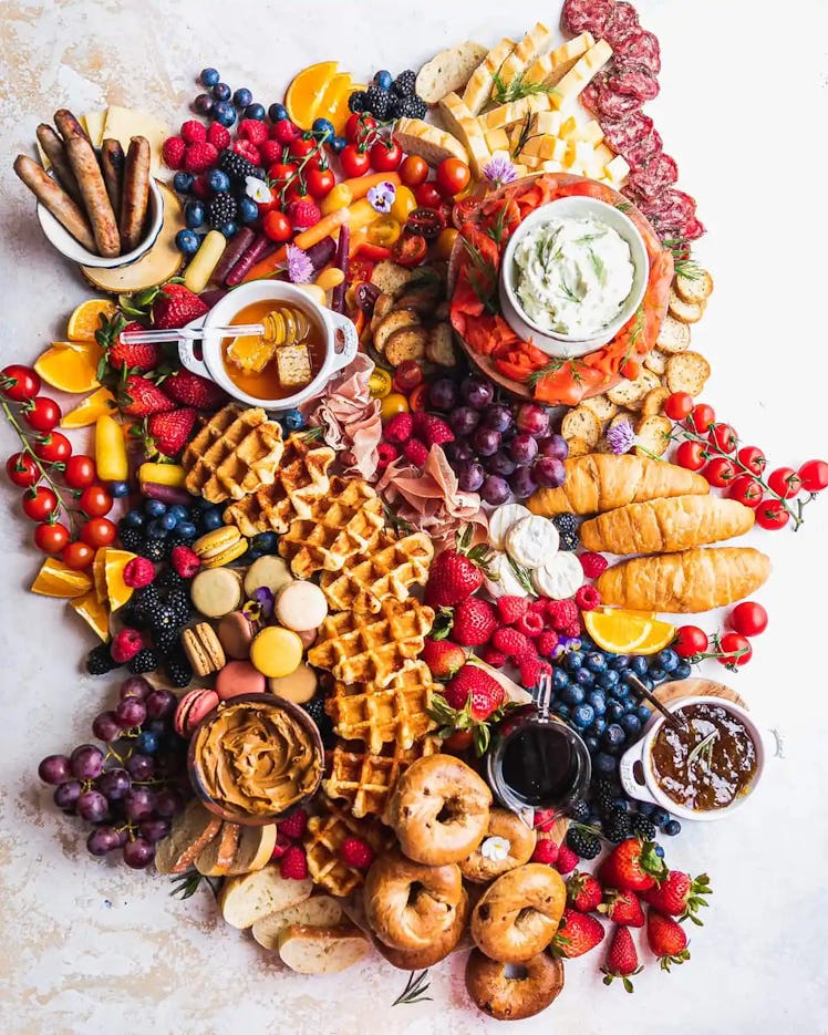 birthday party food idea: breakfast board with waffles, bagels, fruit, and more 