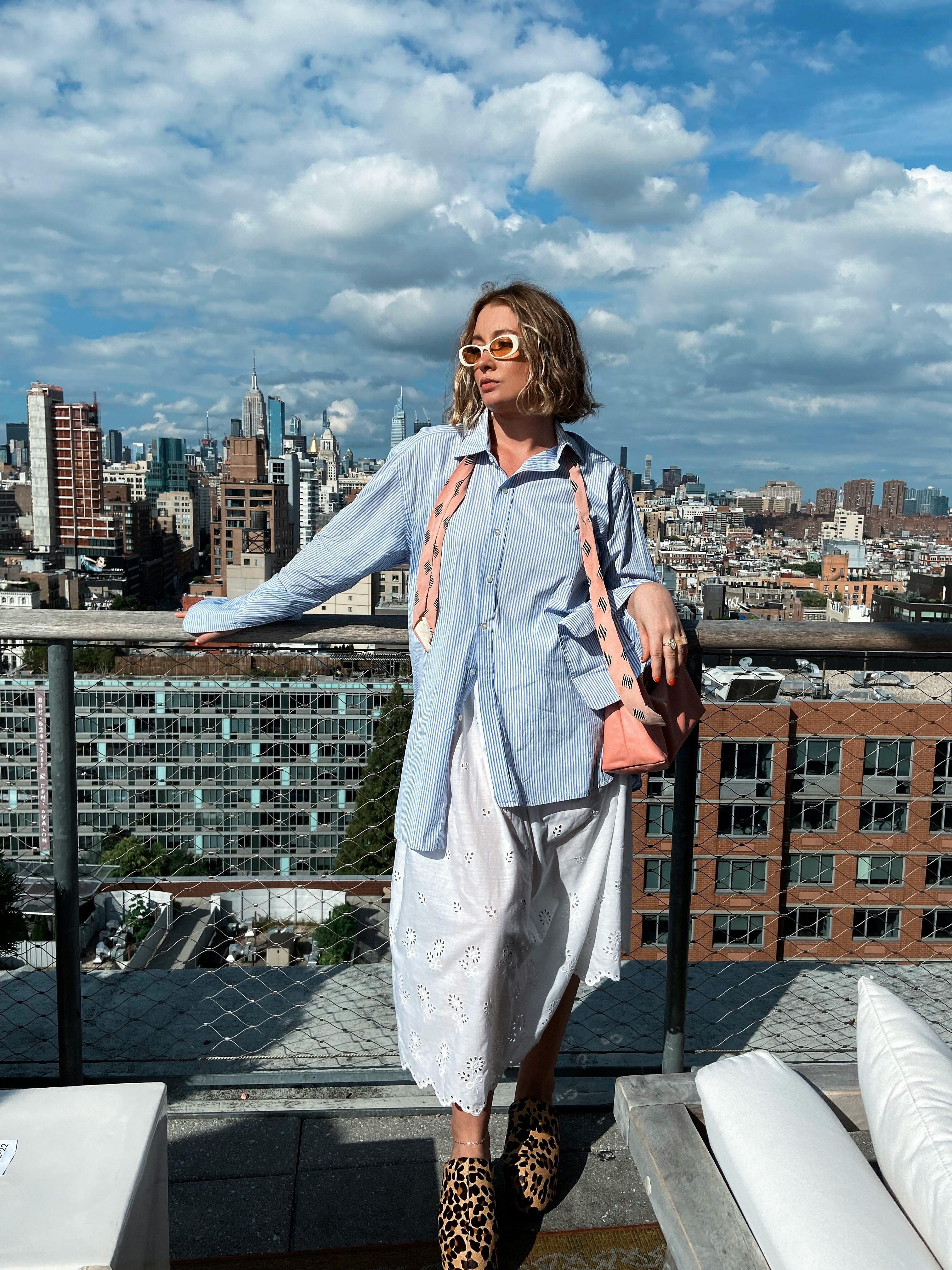 kelsey stiegman wears a blue pin-stripe button-up and eyelet skirt at new york fashion week septembe&hellip;