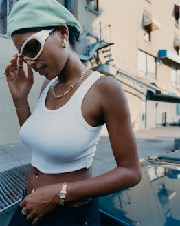 A model wearing white wraparaound sunglasses