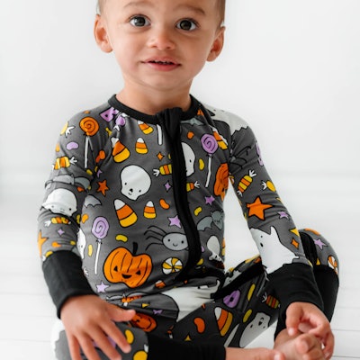 Halloween pajamas for baby in a gray pattern with pumpkins, witches' hats, and more