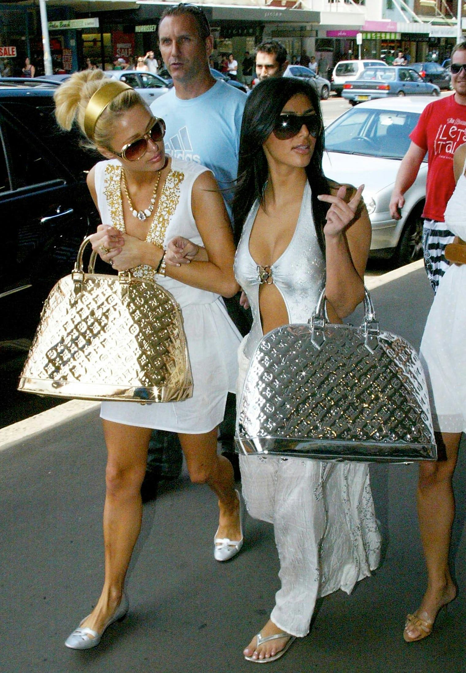 Paris Hilton and Kim Kardashian tote massive metallic Louis Vuitton bags.