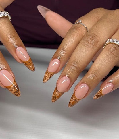 Marbled amber tips are one way to rock caramel nail art this season.