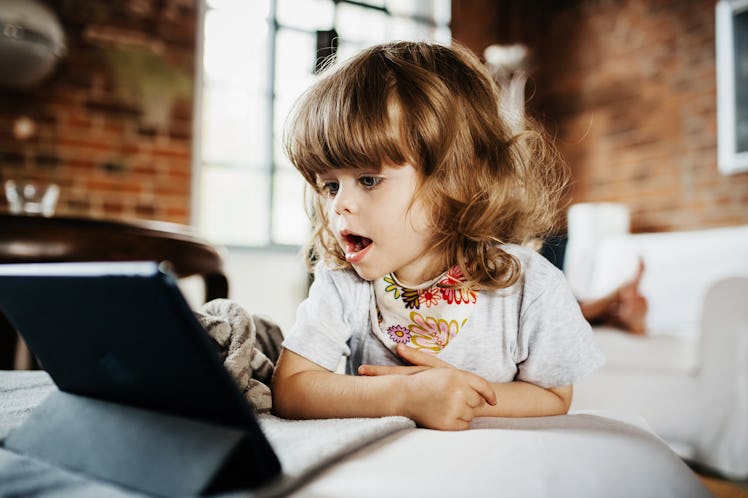 A toddler stares at a tablet that is tracking her eyes for autism diagnosis.