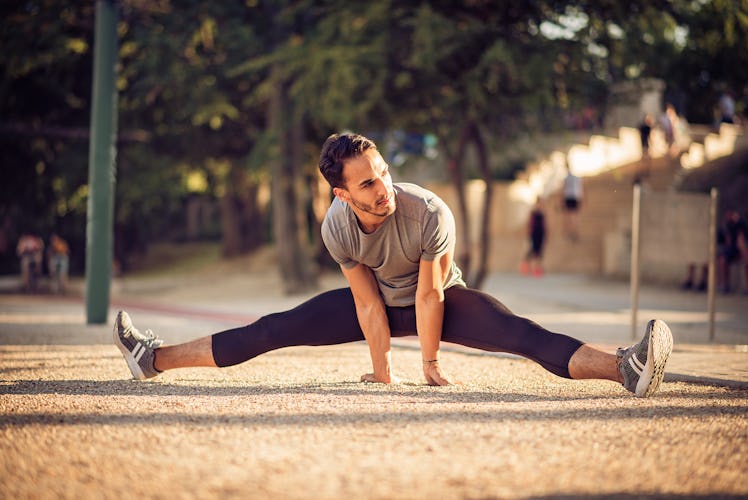 A man doing the middle splits.