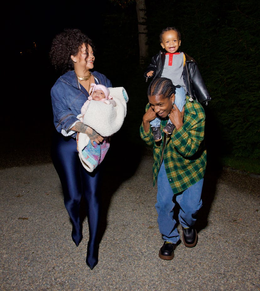 RZA sits on ASAP Rocky's shoulder while Rihanna holds baby Riot. 