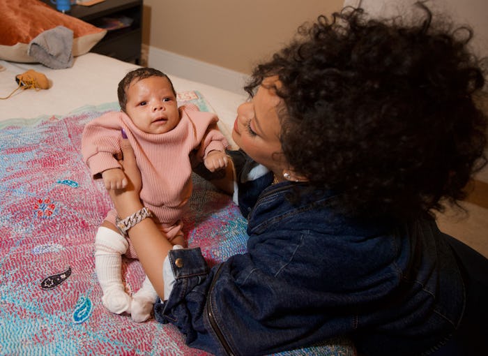 Rihanna poses with her newborn son Riot Rose. 