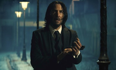 Keanu Reeves holds a gun as John Wick in 'John Wick: Chapter 4'