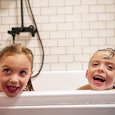 Siblings take a bath together.